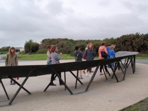 Students read about Pointe du Hoc on the path
