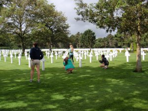 Several students take photos of the vast cemetary